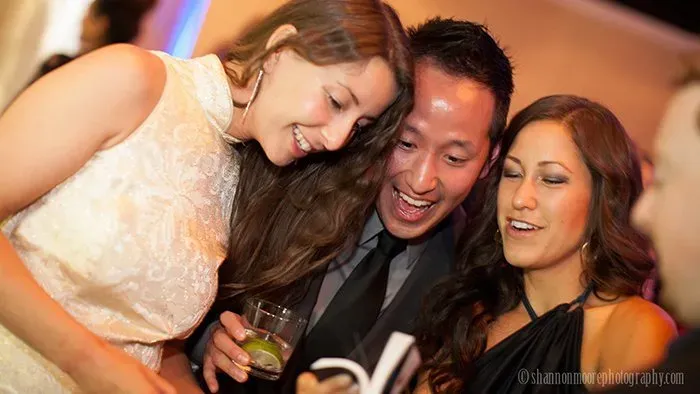 Wedding guests laughing with flipbooks